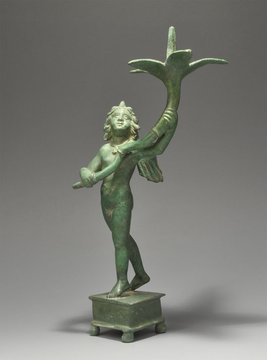 Circa first century large bronze figure of a young winged Eros supporting a long-stemmed cornucopia. Estimate: $28,000-$38,000. Image courtesy of TimeLine Auctions.